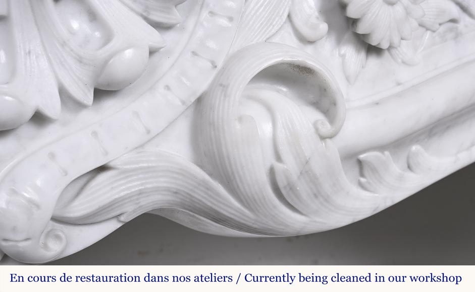 A highly sculpted Louis XV style fireplace in Carrara marble, decorated with a shell motif. A highly sculpted Louis XV style fireplace in Carrara marble, decorated with a shell motif.-5