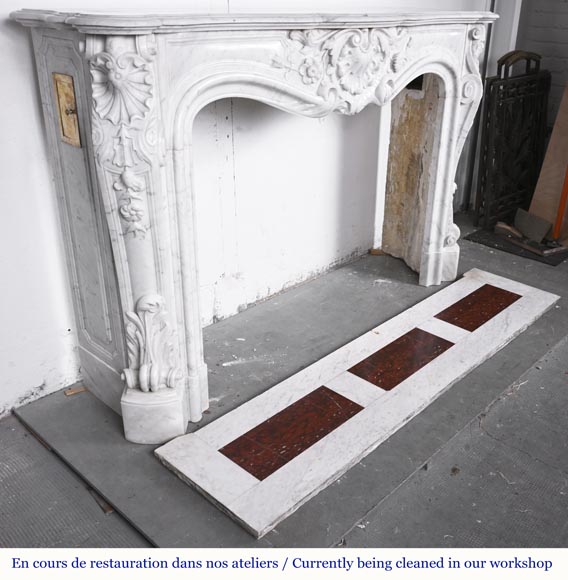 A highly sculpted Louis XV style fireplace in Carrara marble, decorated with a shell motif. A highly sculpted Louis XV style fireplace in Carrara marble, decorated with a shell motif.-6
