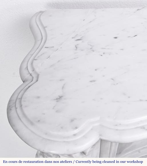 A highly sculpted Louis XV style fireplace in Carrara marble, decorated with a shell motif. A highly sculpted Louis XV style fireplace in Carrara marble, decorated with a shell motif.-16