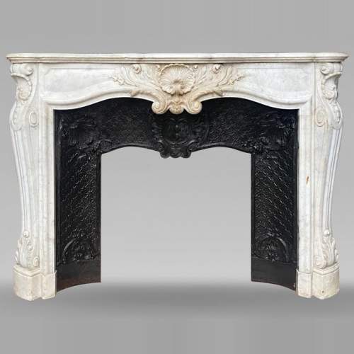 Louis XV style mantel with shell framed by palmettes carved in Carrara marble
