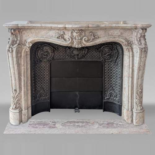 Large Louis XV style curved and finely carved Sarrancolin marble mantel