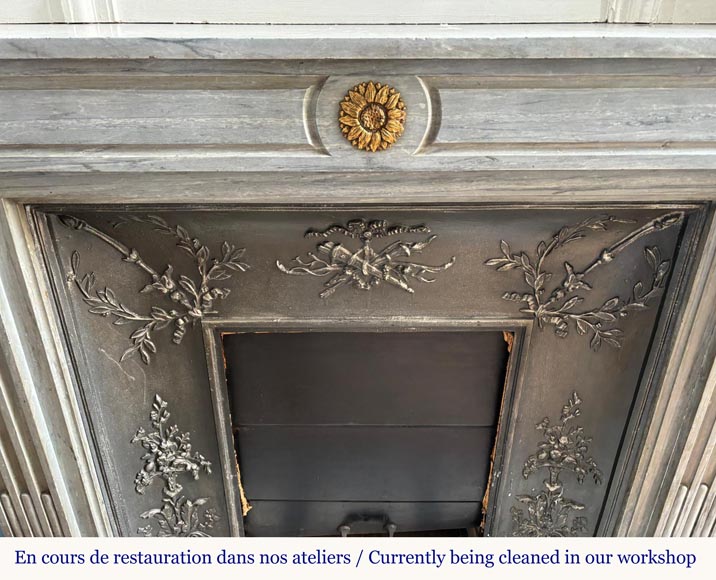 Louis XVI style mantel in light blue Turquin marble decorated with bronze sunflowers Louis XVI style mantel in light blue Turquin marble decorated with bronze sunflowers-1