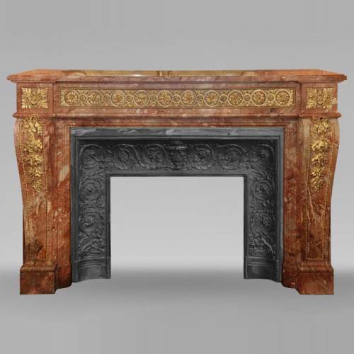 Large Louis XVI style mantel in red breche marble adorned with bronze.