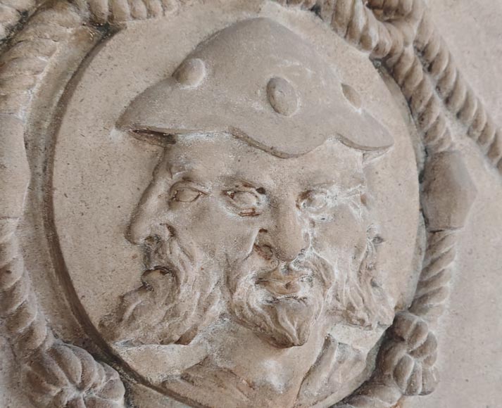 Carved stone fireplace with three-faced mask decoration Carved stone fireplace with three-faced mask decoration-1