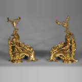 Antique Louis XV style andirons made out of gilded bronze with putti decor
