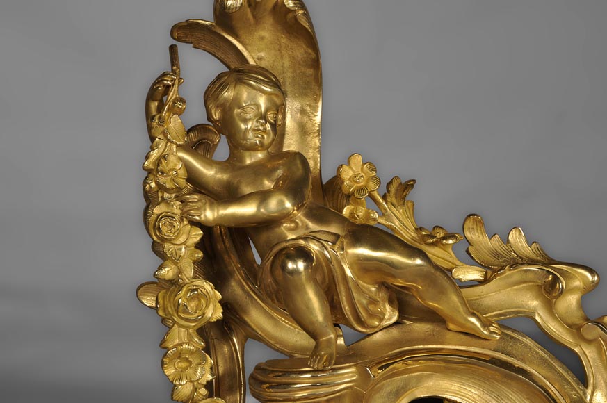 Antique Louis XV style andirons made out of gilded bronze with