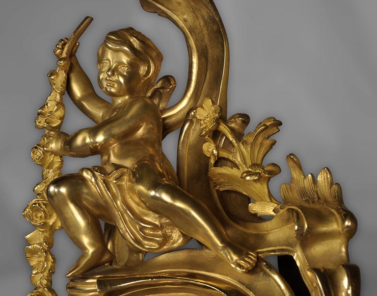 Antique Louis XV style andirons made out of gilded bronze with