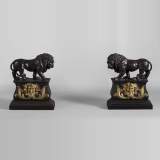 Pair of antique andirons in patinated bronze and gilt bronze with lions and Bacchus' masks, from 19th century.