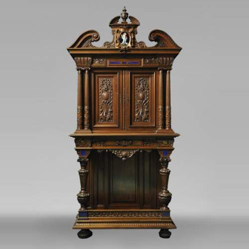 Two-body cabinet, in th Neo-Renaissance style, in carved walnut with enamel and lapis-lazuli inlays