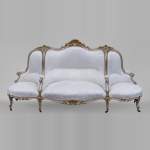 A large Louis XV style bench made out of gilded wood