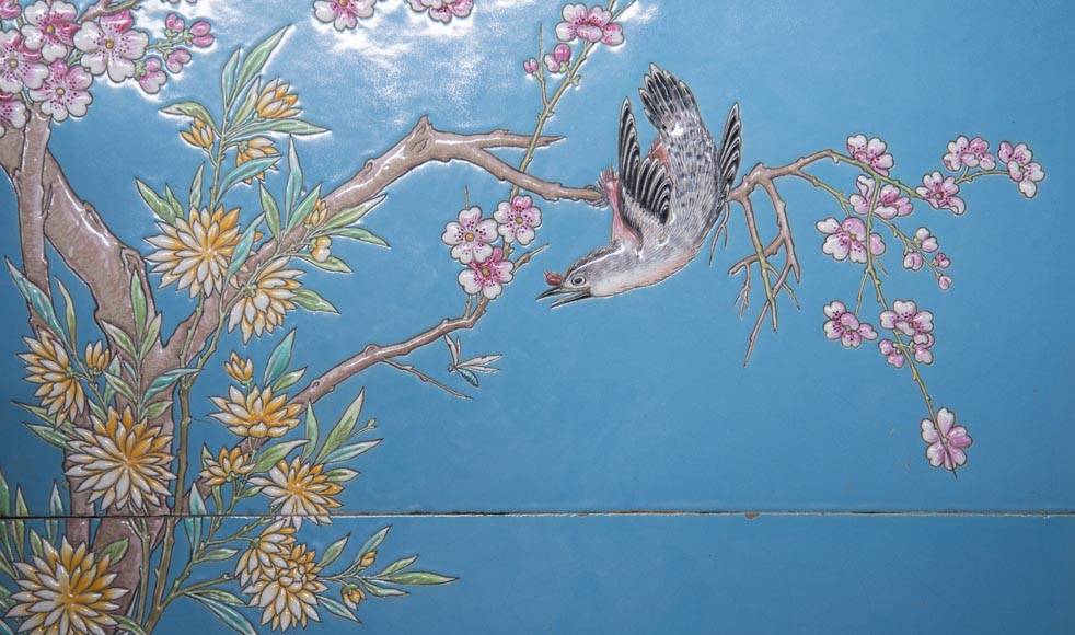 A pair of ceramic panels with birds in a lacustrine scenery signed 