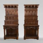 Pair of Neo-Gothic style carved walnut sideboards