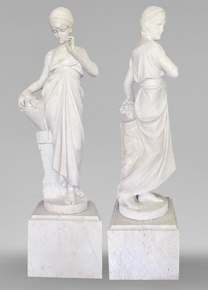 Two white marble statues representing 