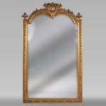 Antique Napoleon III style trumeau in gilded stucco and bevelled mirror