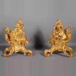 Pair of antique Louis XV style gilt bronze andirons with characters in costume