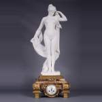 Peach blossom marble and gilt bronze clock surmounted by a statuary white marble   sculpture representing Phryne in front of his judges, signed 