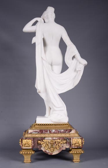 Peach blossom marble and gilt bronze clock surmounted by a statuary white marble   sculpture representing Phryne in front of his judges, signed 