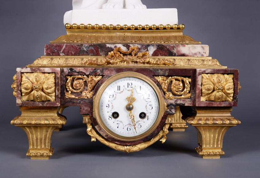 Peach blossom marble and gilt bronze clock surmounted by a statuary white marble   sculpture representing Phryne in front of his judges, signed 