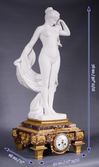 Peach blossom marble and gilt bronze clock surmounted by a statuary white marble   sculpture representing Phryne in front of his judges, signed 