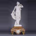 Peach blossom marble and gilt bronze clock surmounted by a statuary white marble   sculpture representing Phryne in front of his judges signed 