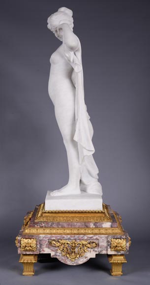 Peach blossom marble and gilt bronze clock surmounted by a statuary white marble   sculpture representing Phryne in front of his judges signed 