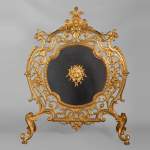 Napoleon III style firescreen in gilt bronze with lion and putto mascaron