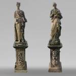Set of two stone sculptures representing female figures dressed as antique mid-19th century 