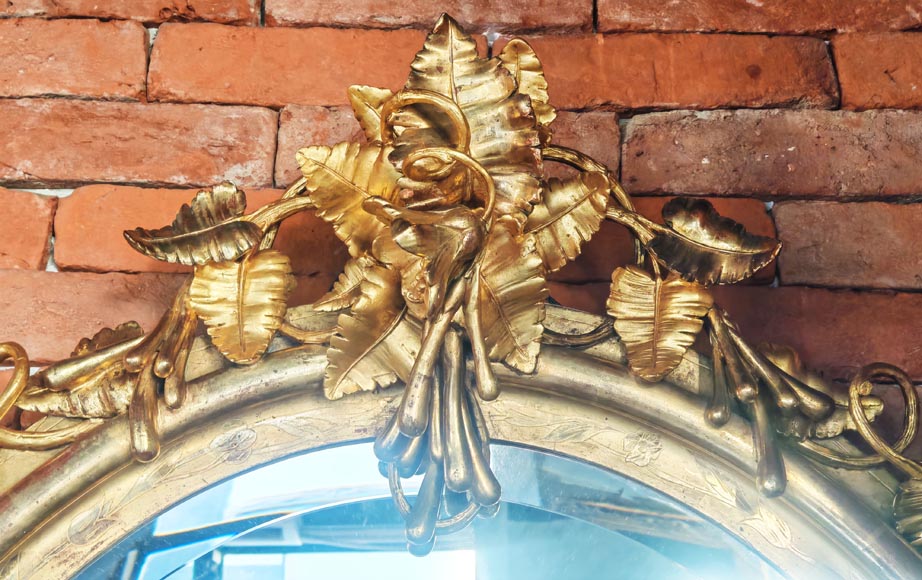 Oval gilt mirror in the Napoleon III style, featuring rich foliate ornamentation Oval gilt mirror in the Napoleon III style, featuring rich foliate ornamentation-1