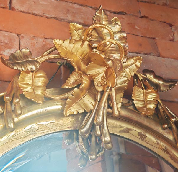 Oval gilt mirror in the Napoleon III style, featuring rich foliate ornamentation Oval gilt mirror in the Napoleon III style, featuring rich foliate ornamentation-2