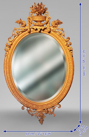 Louis XVI oval mirror in gilt wood with a vase and flowers