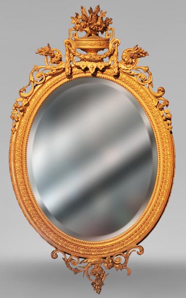 Louis XVI oval mirror in gilt wood with a vase and flowers-0