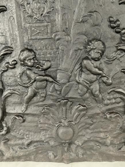 Cast iron fireback with putti firing a cannon-6