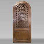 Oak entrance door with open decoration and curved top