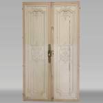 Beautiful sculpted wood double door with a monogram