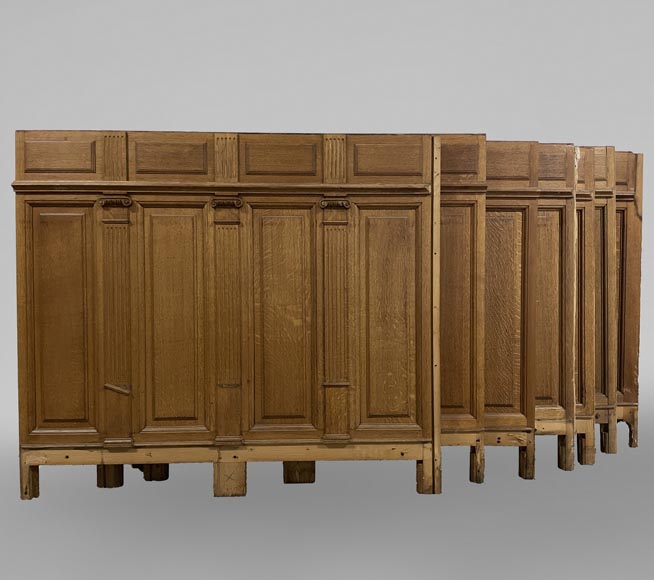 Series of about 10 linear meters of paneled room's bases in oak with Ionic capitals-0