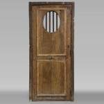 Small antique and simple door in oak with an oval opening