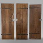 Series of three antique oak doors with their metal hinge