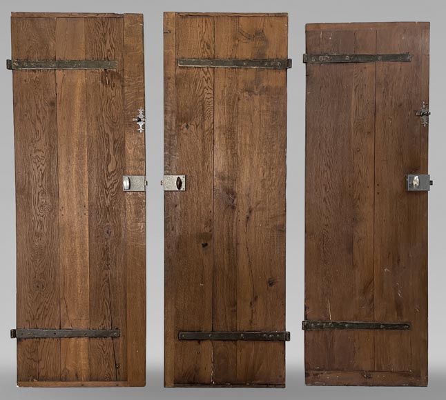 Series of three antique oak doors with their metal hinge-0