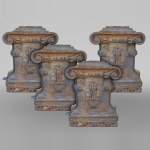 Four cast-iron pilaster bases adorned with a coat of arms