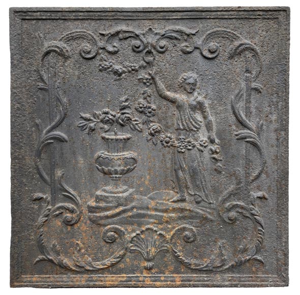 18th century fireback representing a female figure with a flower garland next to an antique vase-1