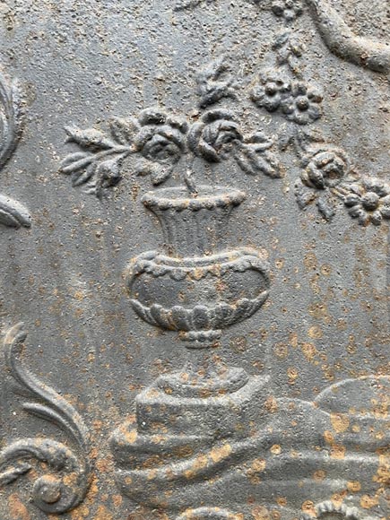 18th century fireback representing a female figure with a flower garland next to an antique vase-4