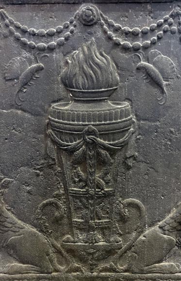 Fireback of the 18th century depicting a vase on a tripod with fire framed by two chimeras supporting baskets of fruit-1