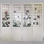 Quadruple sliding door with stained glass windows featuring birds and plants