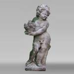 Sculpture of a putto with a flowering basket in composite stone
