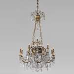 Louis XVI style chandelier in gilt bronze and crystals decorated with rams heads