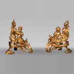 Pair of Louis XV style andirons with putti decoration