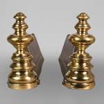 Pair of cast iron and polished bronze andirons