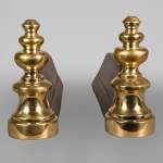 Pair of cast iron and polished bronze andirons