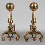 Pair of cast iron and polished bronze andirons