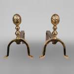 Pair of polished bronze chenets with carved acorns, 19th century